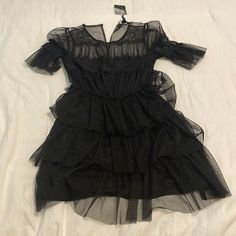 Black Net Ruffle Mini Dress From Forever 21. Never Been Worn Before & Tag Attached. Size: Small. Tiered Ruffle Mini Dress For Night Out, Flirty Black Mini Dress With Ruffled Skirt, Black Summer Ruffle Dress For Date Night, Short Sleeve Ruffle Dress With Ruffle Hem For Party, Black Tiered Dress For Night Out, Black Tiered Dress For Date Night, Black Ruffle Hem Dress For Summer, Black Ruffled Mini Dress For Night Out, Black Ruffled Mini Dress For Date Night