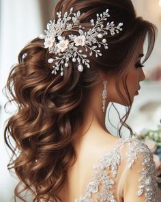 a woman with long brown hair wearing a bridal hairstyle and flowers in her hair