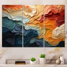 three abstract paintings on a wall in a living room