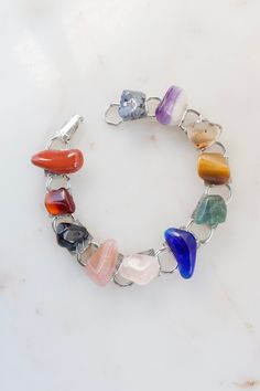 "Vintage Gemstone Link Bracelet. Length: 7\" Width: 3/8\" Weight: 20.4 grams Good vintage condition! Back to the shop: https://www.etsy.com/shop/SusVintage?ref=hdr_shop_menu If you have any questions feel free to contact me. Thank you!!" Vintage Healing Bracelet Jewelry, Vintage Healing Bracelets, Vintage Healing Bracelet, Vintage Multicolor Stone Bracelets, Vintage Agate Bracelet, Vintage Gemstone Beads Bracelet, Metal Crystal Bracelet With Stones As Gift, Metal Crystal Bracelet With Gemstone For Gift, Vintage Stone Bracelets As Gift