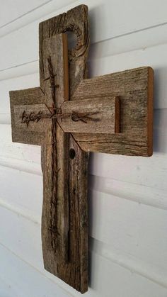 a wooden cross hanging on the side of a building