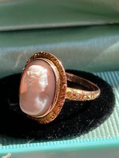 Stunning light pink conch cameo, deeply carved in relief with crisp detail.  Purchased in the UK. Dates to the turn of the 20th century with Austrian hallmarks. 9K gold setting is deeply chased around the bezel and at the shoulders.  Hallmarks present.  Beautiful neoclassical style cameo! Size 7 1/2 Antique Pink Cameo Jewelry, Antique Ring Box, Seed Pearl Ring, Black Onyx Jewelry, Celestial Ring, Gold Starburst, Antique Diamond Rings, Onyx Jewelry, Antique Ring