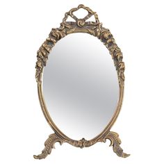 an ornate gold framed mirror on a white background