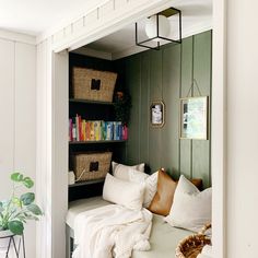 a room with some bookshelves and baskets on the wall