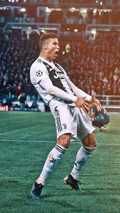 the soccer player is celebrating his goal in front of an empty stadium full of people