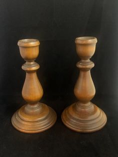 two wooden candlesticks sitting next to each other