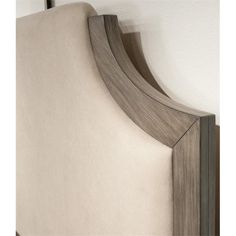 an upholstered headboard with wood trim