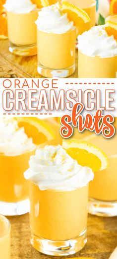 orange creamsicle shots with whipped cream and oranges in the background on a wooden table