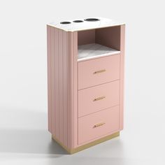 a pink cabinet with three drawers and two black knobs on the top, in front of a white background