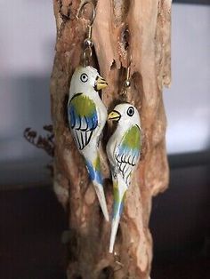 two birds are sitting on top of a piece of wood