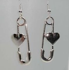 two heart shaped earrings hanging from hooks