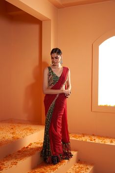 Introducing our striking Red Lehriya Drape Saree with Artsilk Bandhani and Shell detailing, accompanied by a Green Print Bandhani Blouse adorned with Shells and Fringes – a captivating ensemble that seamlessly merges traditional aesthetics with contemporary charm. Traditional Fitted Pre-draped Saree For Navratri, Designer Georgette Pre-draped Saree For Navratri, Bollywood Style Georgette Pre-draped Saree For Navratri, Festive Pre-draped Saree With Dupatta In Georgette, Traditional Floor-length Georgette Pre-draped Saree, Festive Pre-draped Georgette Saree With Dupatta, Bollywood Style Pre-draped Saree For Navratri, Eid Puja Fitted Pre-draped Saree, Red Georgette Sharara With Unstitched Blouse