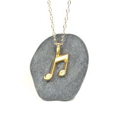 Gold music note necklace - music note - eighth note necklace - a 14k gold plated eighth note on a 14k gold filled chain This perfectly cute and tiny 14k gold plated sterling silver eighth note hangs happily from a 14k gold filled chain in the length of your choice! Please feel free to select a different length chain if you prefer! This beauty is also available in sterling silver. The music note measures 12mm x9mm. Looking for other charm necklaces? https://www.etsy.com/shop/BubuRuby?section_id=1 Personalized Gold Music-themed Jewelry, Necklace Music, Music Note Necklace, Eighth Note, Charm Necklaces, Music Note, Gold Filled Chain, Music Notes, Gold Plated Sterling Silver