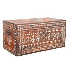 an old wooden box with decorative designs on it