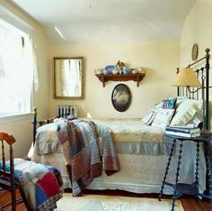 a bedroom with a bed, chair and table in it