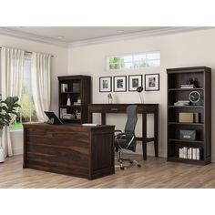 an office with a desk, chair and bookcase in the middle of the room