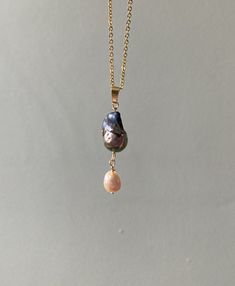 Iridescent, rainbow shifting black flameball pearl pendant, suspending a palest pink pearl teardrop. On an 18inch 18k gold plated chain necklace.  Unique, one of a kind Rose Gold Teardrop Necklace With Pearl Pendant, Rose Gold Jewelry With Teardrop Pearl Pendant, Gold Drop Jewelry With High Luster, Baroque Pearl Teardrop Pendant Necklace With Pearl Drop, Gold Baroque Pearl Drop Necklaces, Teardrop Pearl Chain Necklace, Baroque Pearl Necklace With Teardrop Pendant, Pearl Teardrop Drop Necklace With Pearl Charm, Gold Drop Necklaces With Pearl Charm