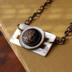 a close up of a book on a chain with a badge attached to it's cover