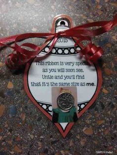 an ornament with a red ribbon around it and a poem on the back