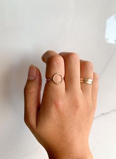 This gold-filled open circle ring is perfect for that simple/dainty look! Choose between a smooth or an organic texture finish. *PLEASE REFER TO DETAILS & CARE BELOW* DETAILS: - This listing includes ONE open circle ring  - Circle is approximately 11 mm - Wire is made of 14k gold-filled material (16 gauge wire) *NOTE:* Because all rings are handmade, you may notice a seam where the joints of the ring have been soldered. RING CARE: - Avoid direct contact with perfumes/makeup/hair spray. Removing jewelry before swimming in chlorinated pools is strongly advised as the chlorine will tarnish your pieces. - Store your pieces in air tight zip bags or a microfiber jewelry pouch - Use a soft polishing or microfiber cloth to clean jewelry. Warm soapy water & soft bristle brush will help with a deepe Everyday 14k Gold Filled Stackable Rings, Dainty Rose Gold Initial Ring For Everyday, Simple 14k Gold Filled Stackable Rings, 14k Gold Circular Metal Ring, Dainty Initial Ring With Round Band For Everyday, Adjustable Initial Ring For Everyday, Dainty Everyday Initial Ring With Round Band, Minimalist Stackable Rings In 14k Gold Filled For Everyday, Minimalist Everyday Stackable Rings In 14k Gold Filled