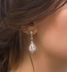 a close up of a woman's ear wearing earrings