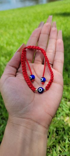 "The Universe serves as your guardian; may you walk your path in protection and peace." Our delicate Handmade Evil Eye Bracelet is beautifully handcrafted to ward off malevolent glares, misfortune, or bad luck. The Evil Eye symbol in the center creates a protective shield around you and deflects all negative energies that can affect your good fortune. Handmade bracelet Adjustable to fit both Men and Women Glass Evil Eye Beads Handmade Spiritual Wristband Bracelet, Handmade Spiritual Bracelet For Friendship, Symbolic Handmade Bracelets For Friendship, Adjustable Spiritual Braided Bracelet With Evil Eye, Adjustable Braided Evil Eye Bracelet For Spiritual Protection, Adjustable Spiritual Evil Eye Braided Bracelet, Symbolic Hand-strung Adjustable Beaded Bracelets, Handmade Spiritual Wristband For Festivals, Spiritual Handmade Wristband For Festivals