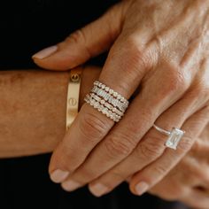 an older woman's hand with three rings on it