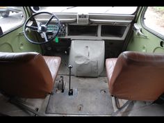 the interior of an old car with leather seats and steering wheel, including one seat