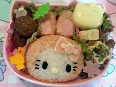 a hello kitty sushi bowl with rice, broccoli and other foods in it