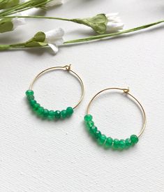 Emerald Hoop Earrings. Ten faceted emeralds adorn each hoop for a total of 20 emeralds in these beautiful earrings! These are perfect with jeans and a t-shirt or to wear with your best outfit! The hoops measure 1-1/4 inches in length and width or just over 3 cm. These earrings are available in either gold plated or rhodium plated finish. Emerald is the May birthstone. Your emerald hoop earrings will arrive gift boxed. If this is a gift, I would be glad to include a card with your personal messag Faceted Earrings For May Birthstone, Faceted May Birthstone Round Earrings, Faceted Hoop Jewelry For Gifts, Elegant Hoop Earrings With Faceted Beads, May Birthstone Round Hoop Earrings, May Birthstone Round Hoop Earrings For Pierced Ears, Faceted Hoop Earrings As Gift, Small Hoop Jewelry With Faceted Beads For Gifts, Small Hoop Earrings With Faceted Beads For Gift