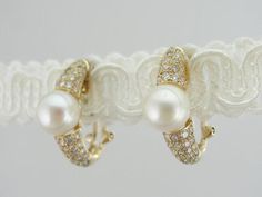 These vintage earrings are in excellent condition. Large pearls, with their bright white color and soft luster are sophisticated and yet sexy at the same time. The diamond accents bring some glitter to these pieces, easy to wear with a suit or a wedding dress! Metal: 18K yellow gold Stone: White Pearl, 8.5 mm Accent: 92 diamonds = 1.32 carat Earring Length: 22 mm Earring Width: 8.5 mm Mabe Pearl, A Wedding Dress, Gold Stone, White Pearl, Eternity Bands, Vintage Earrings, Pearl White, Bright White, White Color