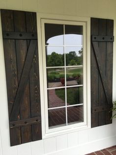 an open window with wooden shutters on the outside