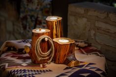 three wooden candles sitting on top of a table