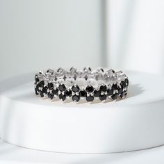 Product Details Enhance your style with the sparkling beauty of this black spinel ring, designed to bring a touch of glamour to your life. The round-cut black spinel, securely nestled in a prong setting on a full eternity band, adds versatility to this exquisite piece, making it suitable for any outfit or occasion. Product Information SKU SHP-RINGS0821188905 Width 2.7 mm Height 4.8 mm Weight 2.72 gm (Approximate) BLACK SPINEL INFORMATION No.of Stones 57 Pieces Total Weight 1.71 Carat (Approximat White Rings, Black And White Rings, Black Spinel Ring, Spinel Ring, Eternity Rings, 18k Yellow Gold Ring, Black Spinel, Eternity Band, Eternity Bands