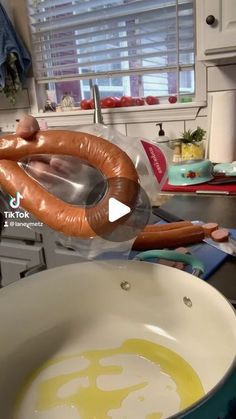 a hot dog is being cooked in a frying pan on the kitchen counter top