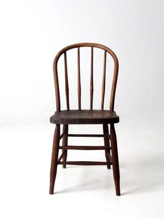 a wooden chair sitting on top of a white floor