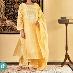 Straight-Fit Kurta Set In Luxe Chanderi Hand-Embroidered With Chikankari Work Comes With An Inner Yellow Bollywood Mulmul Sharara, Yellow Bollywood Sharara, Unstitched Yellow Mulmul Sharara, Yellow Unstitched Mulmul Sharara, Yellow Mulmul Sharara With Dabka Work, Yellow Sharara With Dabka Work In Mulmul, Yellow Mulmul Sharara With Dupatta, Yellow Mulmul Palazzo Set For Navratri, Unstitched Yellow Kurta With Chikankari Embroidery