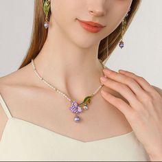 Elevate your style with our Iris Flower Pearl Necklace. The fabulous iris flower pendant, delicate enamel finish, and shinning gemstones add glamour to any outfit. The iris, with its vibrant colors and graceful sway, is a messenger of love and longing, resembling freedom, wisdom, glory, and romance. In Greek mythology, it is the rainbow goddess, and a symbol of royal power in France. A pearl chain with gentle natural allure complements the sophisticated design, making it a dreamy addition to you Elegant Enamel Flower Shaped Jewelry, Elegant Enamel Flower Pendant Jewelry, Elegant Enamel Wedding Necklaces, Flower-shaped Enamel Jewelry For Wedding, Flower Shaped Enamel Jewelry For Wedding, Enamel Flower-shaped Jewelry For Wedding, Purple Enamel Pendant Jewelry, Flower Shaped Enamel Wedding Jewelry, Enamel Flower Shaped Wedding Jewelry