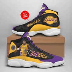 a pair of lakers shoes with the number 24 on them, sitting on top of a cardboard box