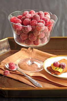 raspberries in a glass bowl on a tray