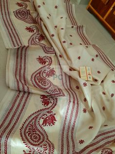 a white and red table cloth with designs on it