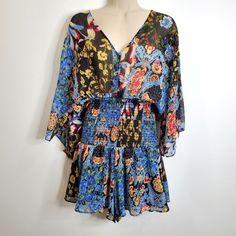 Zara V Neck Style Loop Button Up Playsuit. Flowy Split Open Back With Loop Button Closure. Patchwork Floral Mutli Patterned All Over Print. Smocked Bodice Romper With Shorts. Partially Lined. Size: Small. New With Tags. Sku: Io2328-J Blue Jumpsuits And Rompers With Smocked Back For Beach, Blue Vacation Jumpsuits And Rompers With Smocked Bodice, Blue Jumpsuits And Rompers With Elastic Waistband For Vacation, Blue Jumpsuit With Elastic Waistband For Vacation, Blue Summer Jumpsuits And Rompers With Elastic Waistband, Blue Summer Jumpsuits With Elastic Waistband, Spring Beach Patchwork Jumpsuits And Rompers, Casual Multicolor Jumpsuits And Rompers With Elastic Waistband, Blue Jumpsuits And Rompers With Elastic Waistband For Spring