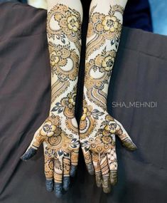 two hands with henna designs on them