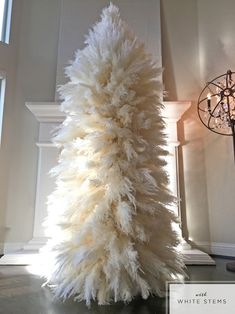 a white christmas tree in the middle of a room