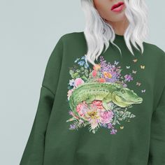 Sweatshirt with Floral Alligator: Shirt for Animal Lover | Funny Cottagecore Crocodile Sweatshirt, Kitschy Eclectic Aesthetic Gift for Her -------- Sweatshirt: Floral Alligator Retro Inspired Sweatshirt Loose Fitting Sweatshirt Runs True to Size 50% Cotton, 50% Polyester Shirt Brand: Gildan 18000 -------- SIZING: Width x Length x Sleeve Length (Inches) S: 20 x 27 x 20 M: 22.01 x 28 x 21.02  L: 24 x 29 x 22.01 XL: 25.98 x 30 x 22.99 2XL: 28 x 31 x 24.02 3XL: 30 x 32 x 25 4XL: 32 x 32.99 x 26.02 5 Green Dinosaur Print Tops For Spring, Green Dinosaur Print Top For Spring, Funny Cottagecore, Eclectic Aesthetic, Aesthetic Gift, Spring Nights, Polyester Shirt, Shirt Brand, Retro Inspired