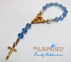 a rosary with a gold cross and blue beads