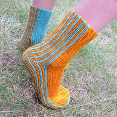 a person standing in the grass wearing socks