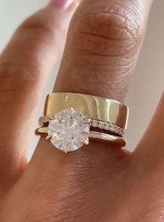 a woman's hand with a ring on it and a diamond in the middle