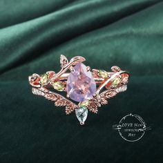 Art Deco Pear Lavender Amethyst engagement ring Bridal Set Rose Gold Unique Leaf Nature Inspired  Gemstone Promise Cluster ring jewelry Gift (Please comfirm your US size when you make an order) Jewelry details: Matal Type: 14k gold /18k gold Engagement Ring: Center Stone: Lavender Amethyst Stone Size: 6*8mm Side stones: peridot Total weight: 0.18ctw (High Quality) Wedding band Moss Agate and moissanite Carat Weight: approx. 0.182ctw Or: black sapphire (If you choose side stone in black sapphire) Purchase Guarantee: 1: Provide you with the best service. 2: 14 Day Refund Guarantee. 3: Free Gift Box&Packing 4: Free Shipping and insurance to All Parts Of The World. Accessories: beautiful Ring box, and little gifts. Processing time: When we receive payment We need 2-3 weeks to work for your ite Exquisite Amethyst Wedding Ring With Gemstone Accents, Exquisite Amethyst Ring For Wedding, Purple Amethyst Ring With Rose Cut Diamonds For Wedding, Rose Gold Amethyst Ring With Gemstone Accents For Wedding, Purple Rose Cut Diamond Jewelry For Wedding, Pink Amethyst Ring With Gemstone Accents For Wedding, Fine Jewelry Amethyst Ring With Gemstone Accents For Wedding, Rose Cut Amethyst Jewelry For Wedding, Lavender Gemstone Jewelry For Promise