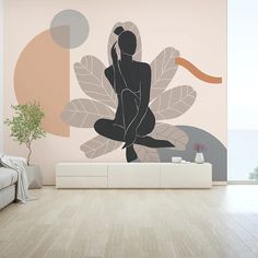 a living room with a couch, coffee table and large wall mural on the wall